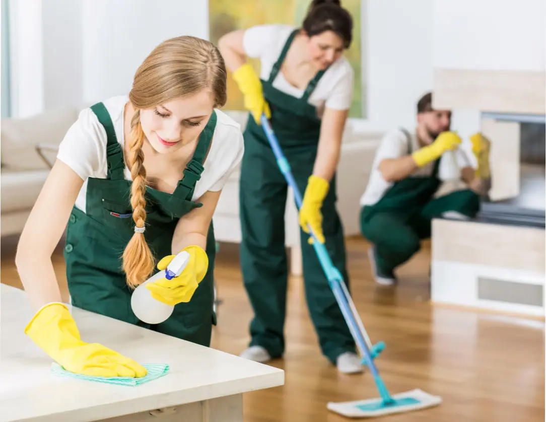 Team of three cleaners in white shirts